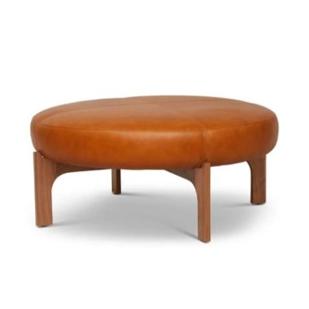 Timo ottoman with round upholstered leather top and solid wood legs in a modern interior style